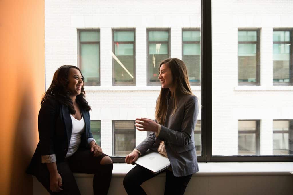 women in an office talking