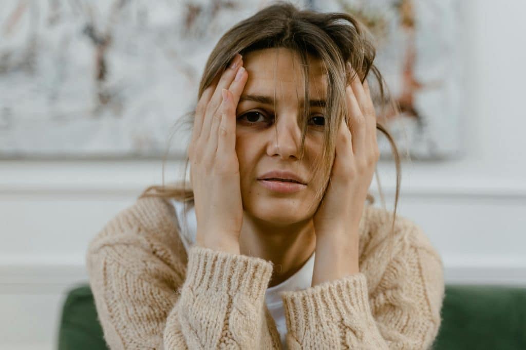 woman with a bruise on eye and crying