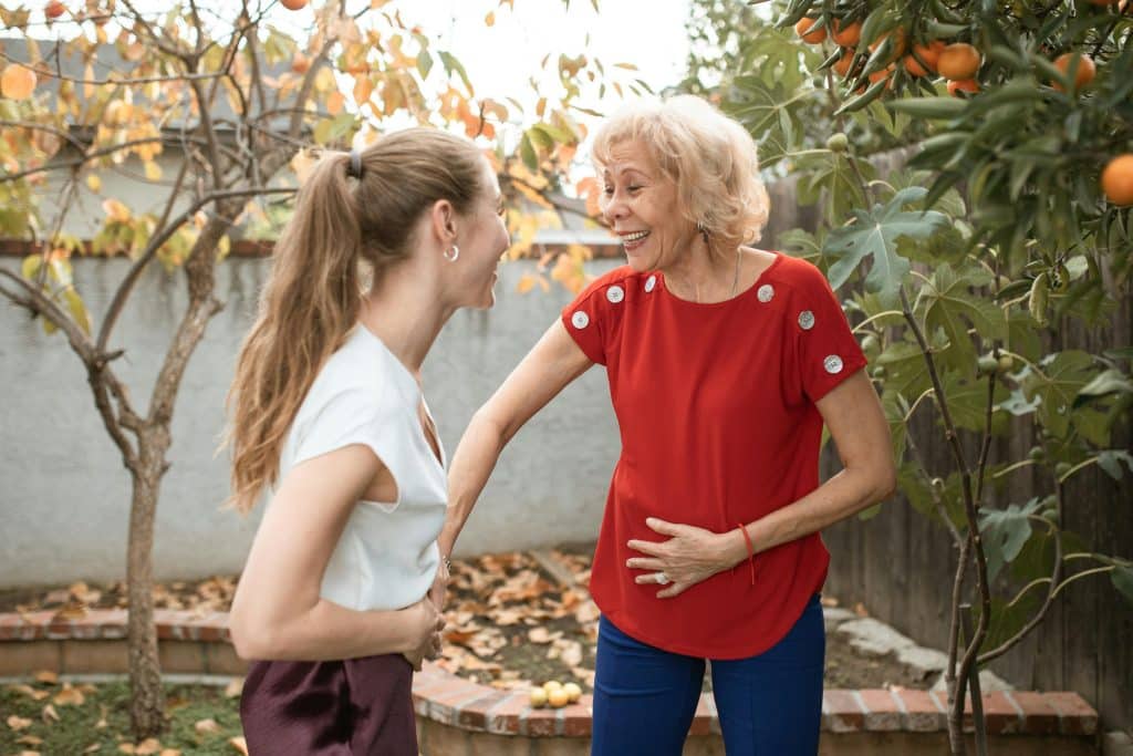 two women talking to each others outside
