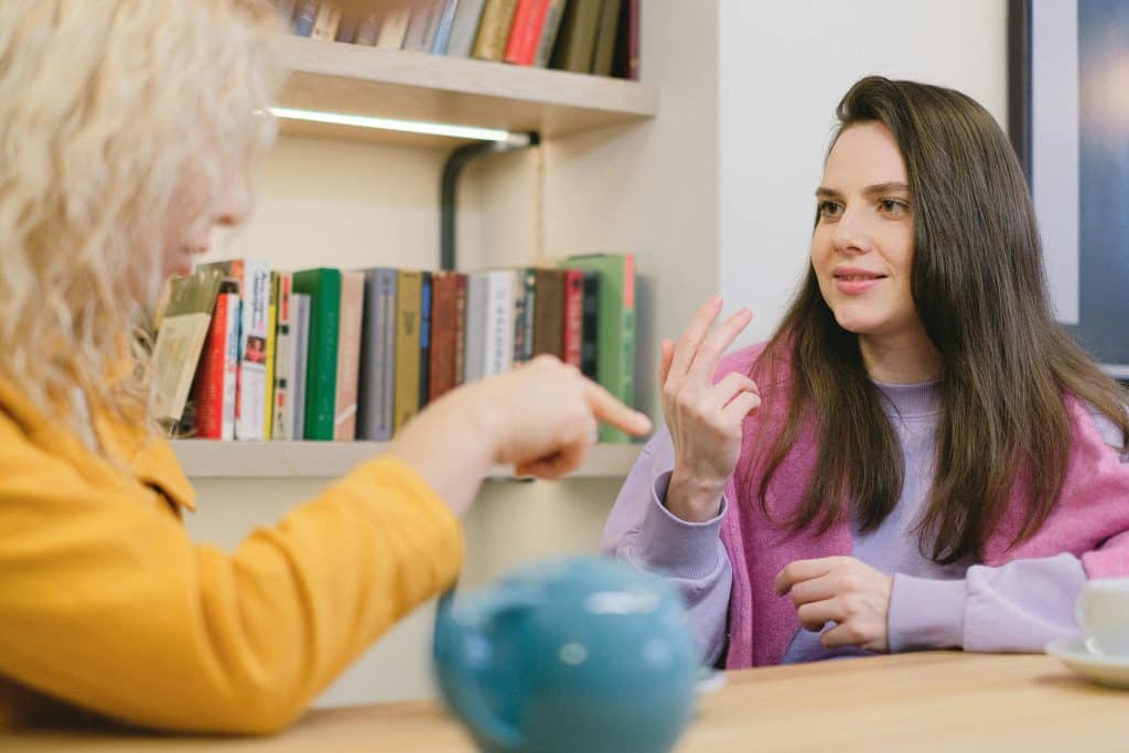 two women talking to each others at an office of a Women's Outpatient Center